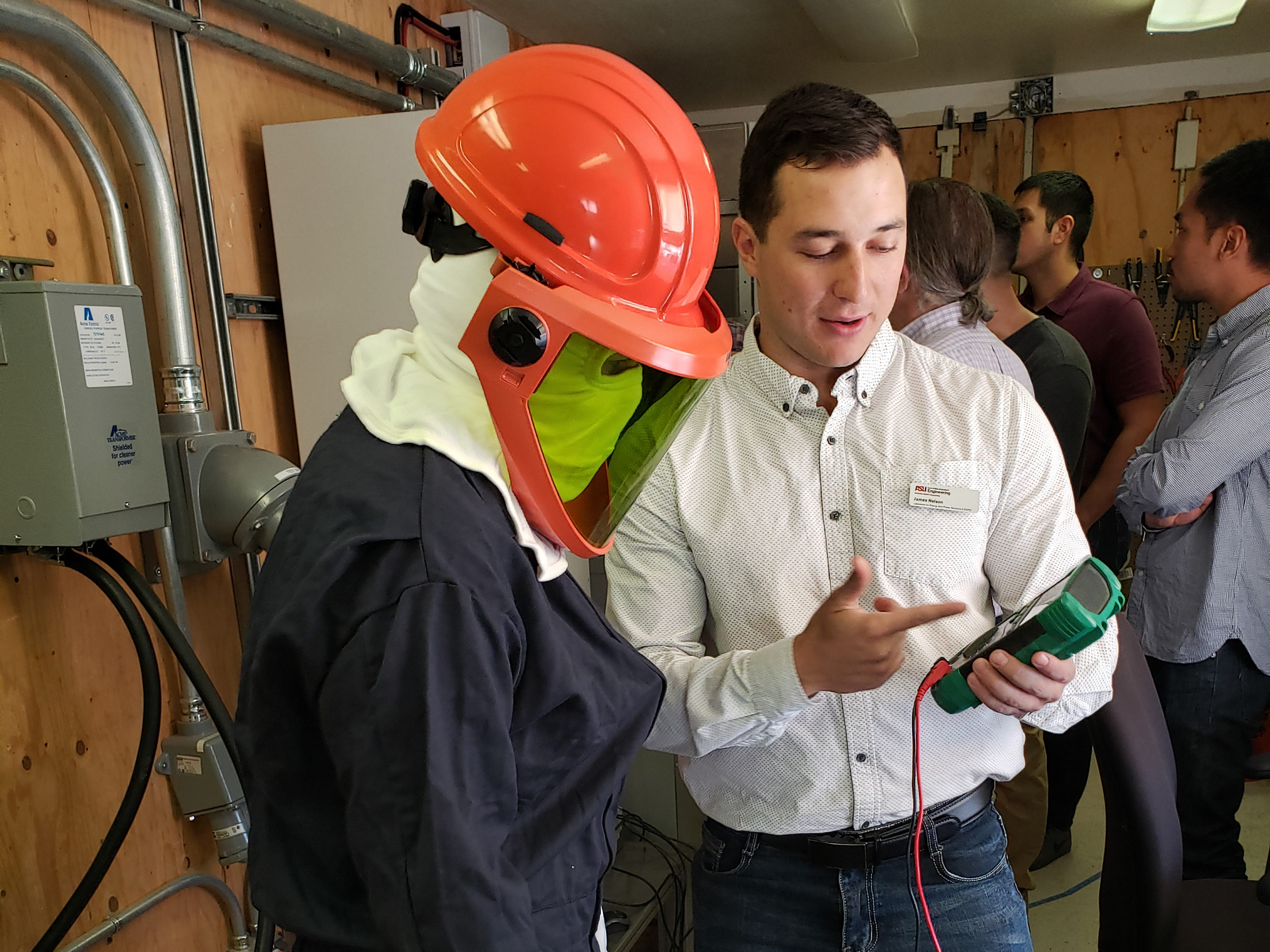Image of instructor teaching a microgrid bootcamp attendee who is in protective gear.